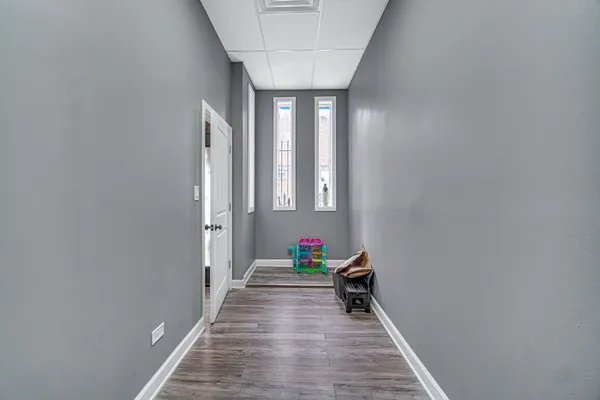 a view of hallway with stairs and wooden floor