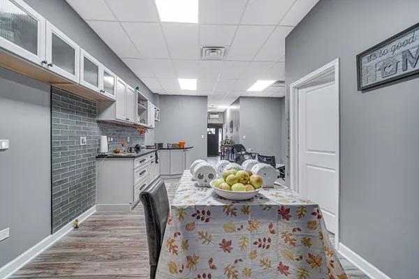 a view of a kitchen and dining room with wooden floor