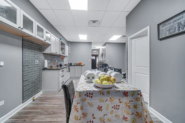 a view of a kitchen and dining room with wooden floor