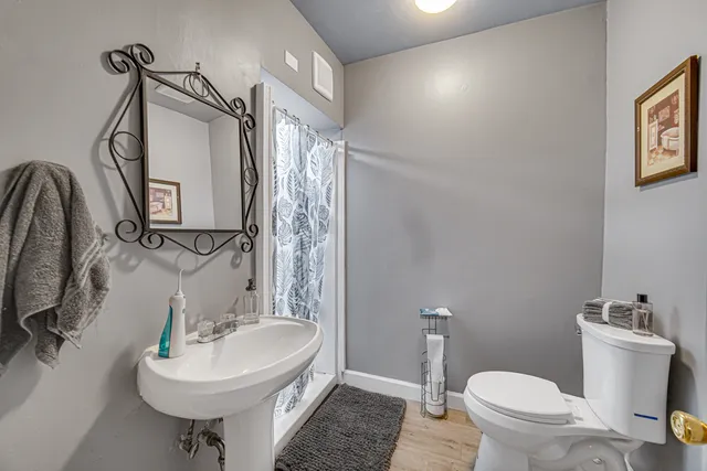 a bathroom with a sink toilet and a mirror