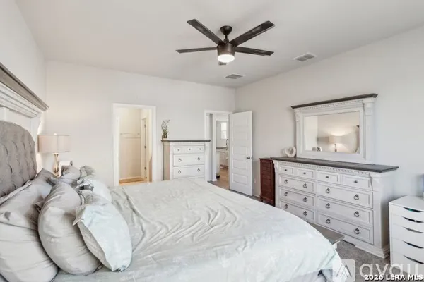 a bedroom with a large bed and a window