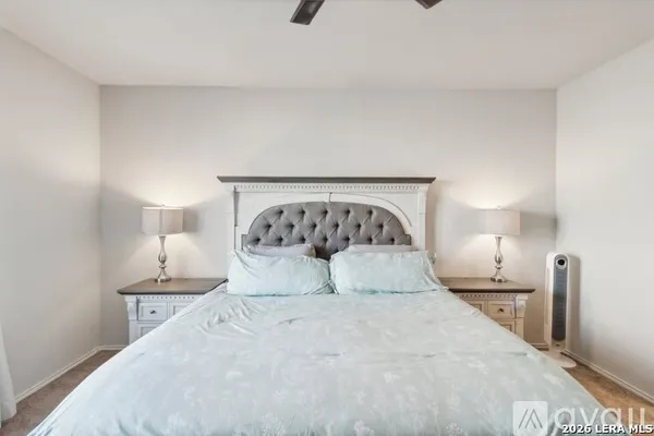 a bedroom with a bed and a night stand