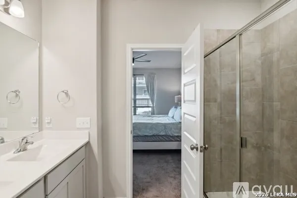 a en suite bathroom with a sink a mirror and a shower