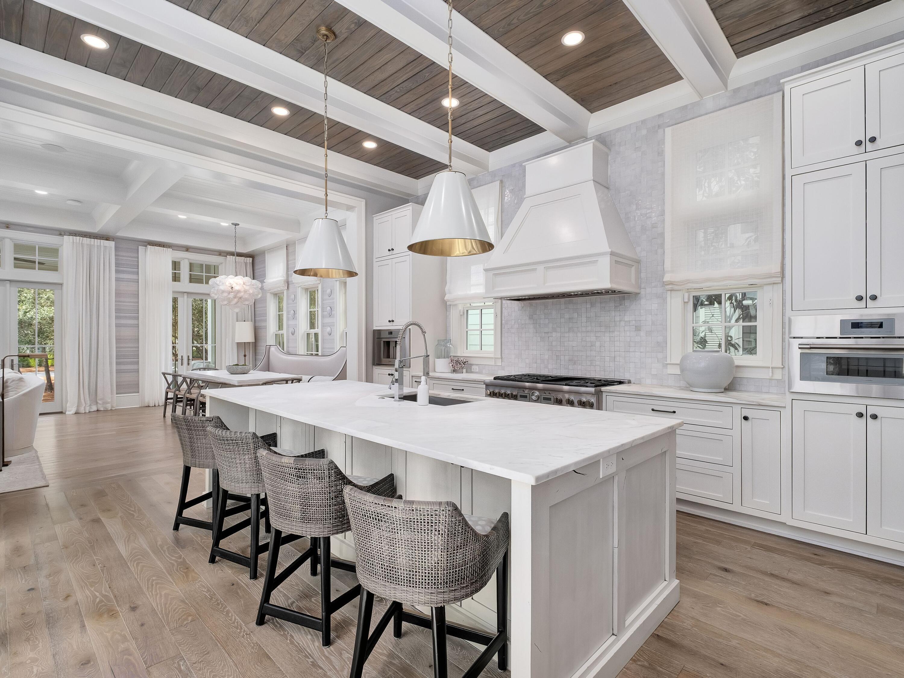 26 Rain Lily Lane Santa Rosa Beach, FL 32459 - Photo 12 of 45 a kitchen with a stove a table and chairs in it