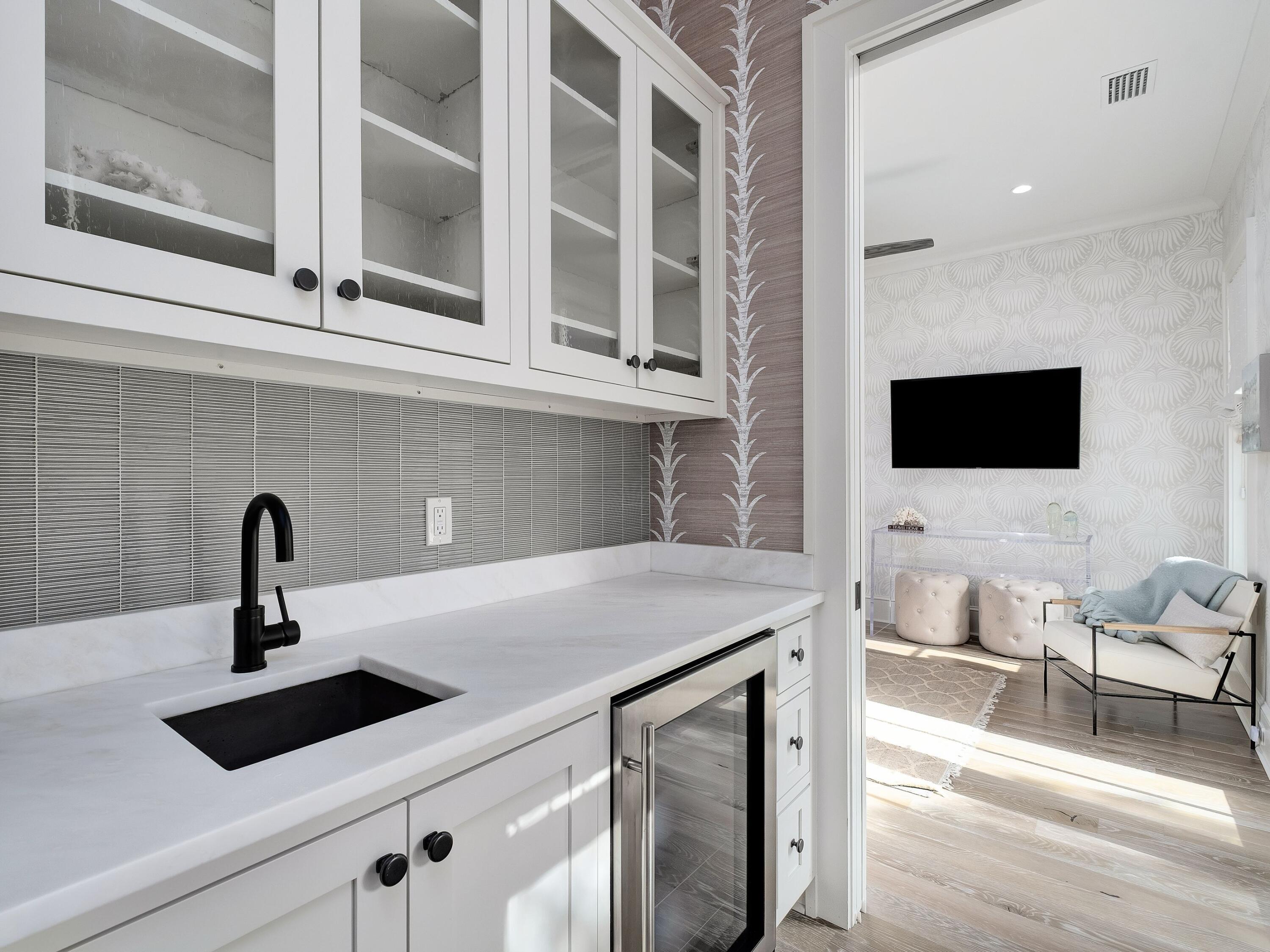 26 Rain Lily Lane Santa Rosa Beach, FL 32459 - Photo 20 of 45 a kitchen with a sink and a flat screen tv
