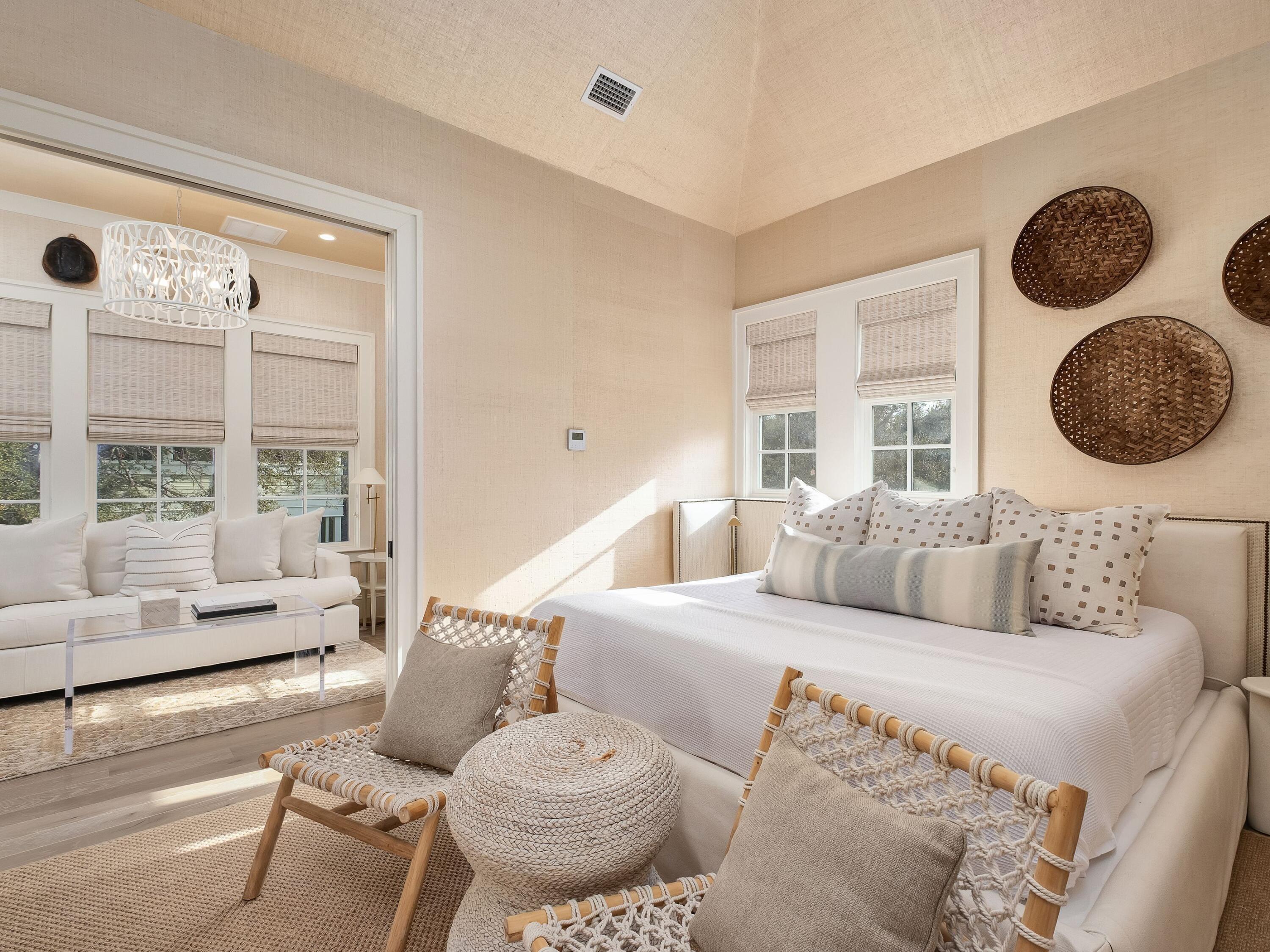 26 Rain Lily Lane Santa Rosa Beach, FL 32459 - Photo 30 of 45 a large white bed sitting in a room next to a window and a chandelier