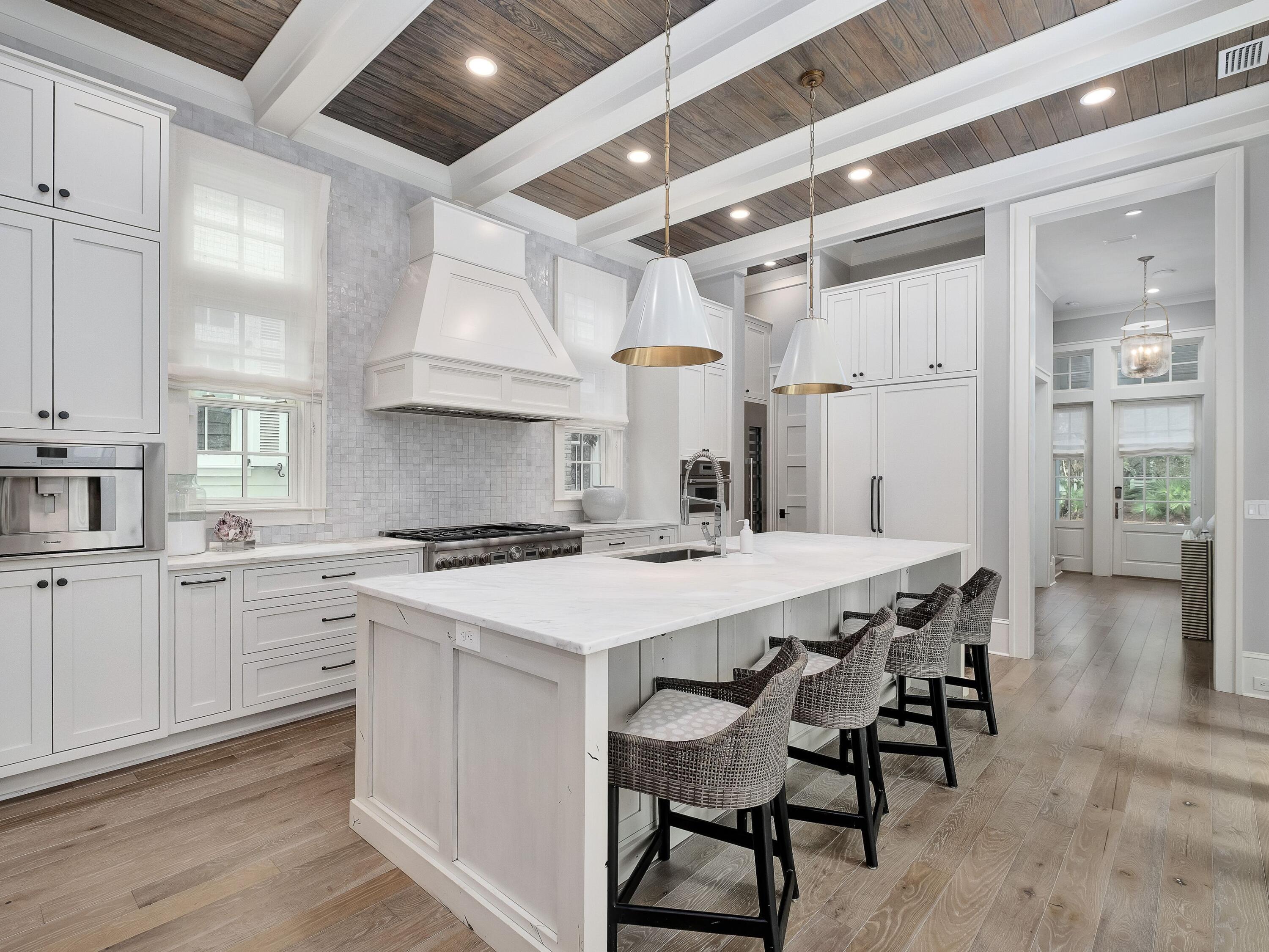 26 Rain Lily Lane Santa Rosa Beach, FL 32459 - Photo 3 of 45 a kitchen with a stove a table and chairs in it