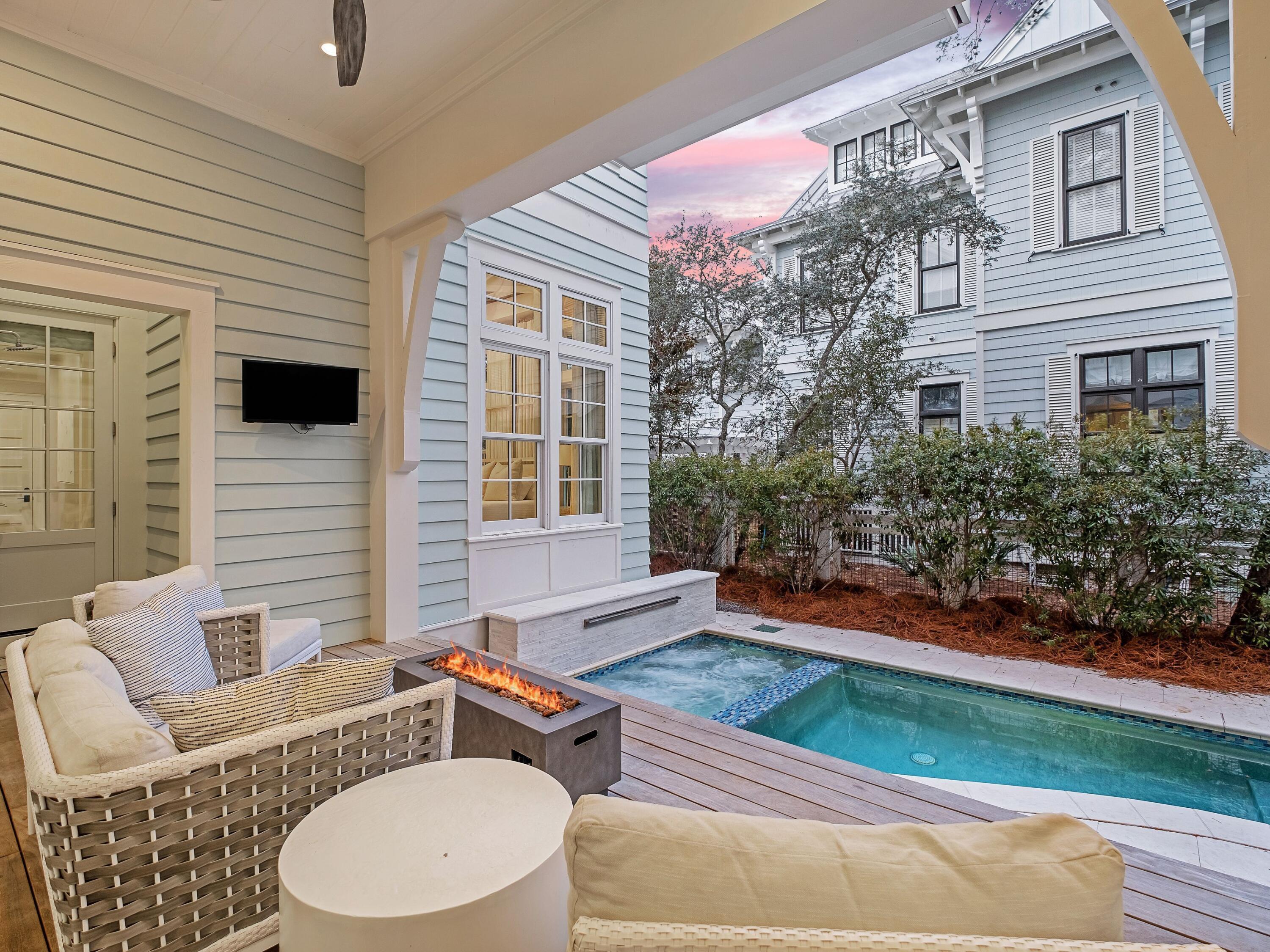 26 Rain Lily Lane Santa Rosa Beach, FL 32459 - Photo 6 of 45 a backyard of a house with wooden floor chairs and outdoor seating
