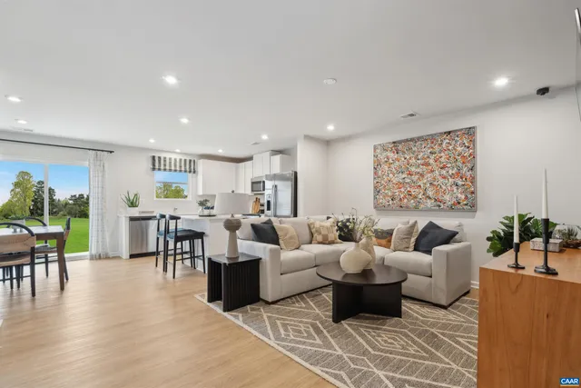 a living room with furniture dining area and a view of kitchen