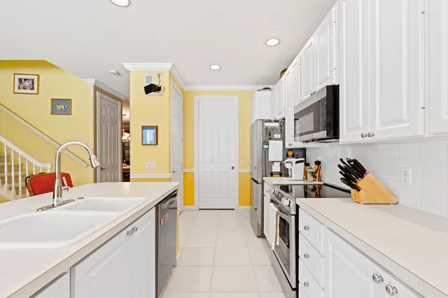 a kitchen that has a sink and a stove in it