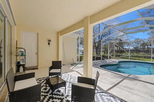a living room with fireplace furniture and a floor to ceiling window