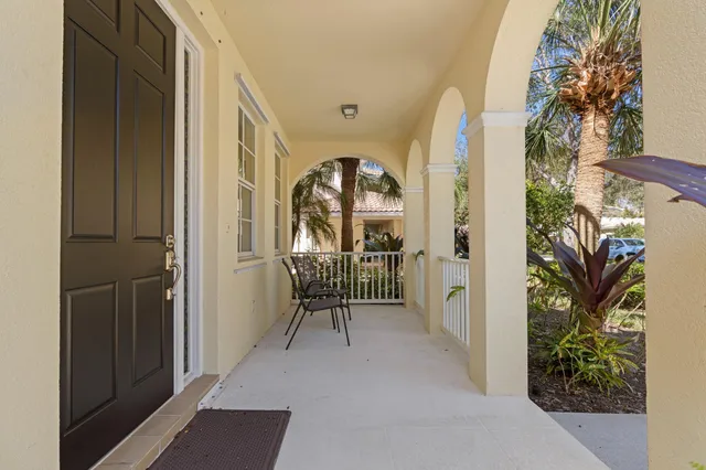 a view of a hallway with wooden floor and a potted plant