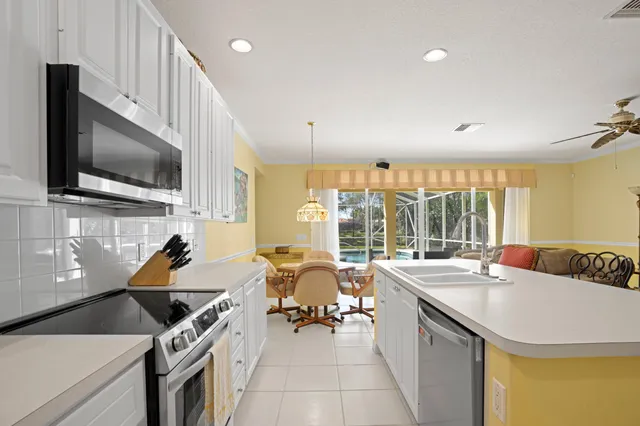 a open kitchen with stainless steel appliances granite countertop a sink and a stove