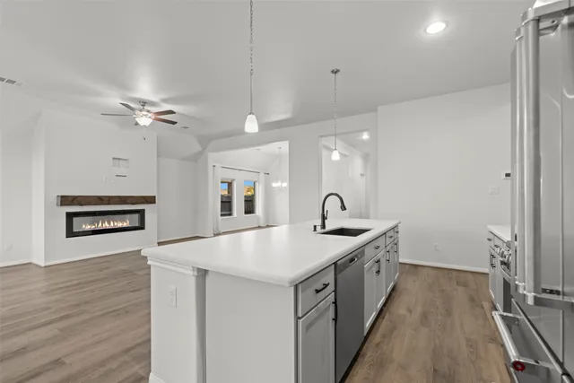 a kitchen with a sink and a stove top oven