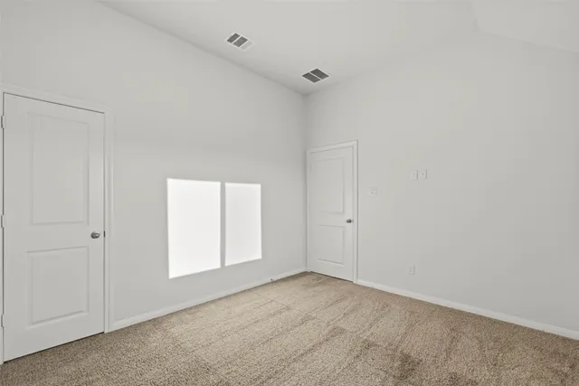 a view of an empty room and a window