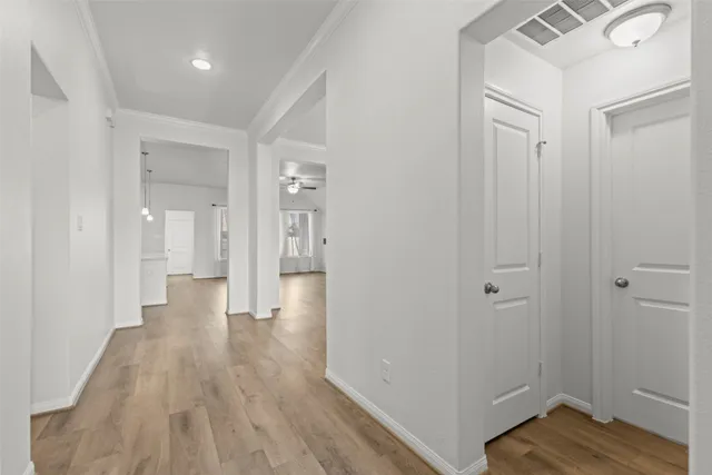 a view of a hallway with wooden floor
