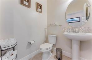 7211 Still Pond Lane Windermere, FL 34786 - Photo 12 of 17 a bathroom with a toilet sink and mirror