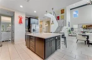 a kitchen with stainless steel appliances kitchen island granite countertop a table and chairs in it
