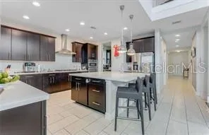 a kitchen with stainless steel appliances kitchen island granite countertop a sink and cabinets
