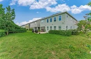a view of a house with backyard and garden
