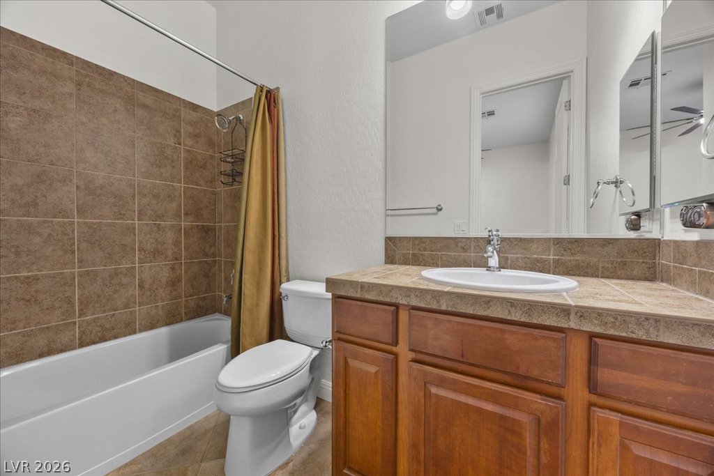 2125 De Rouge Avenue Henderson, NV 89044 - Photo 65 of 96 A well-appointed bathroom features a bathtub, toilet, and vanity with ample storage.