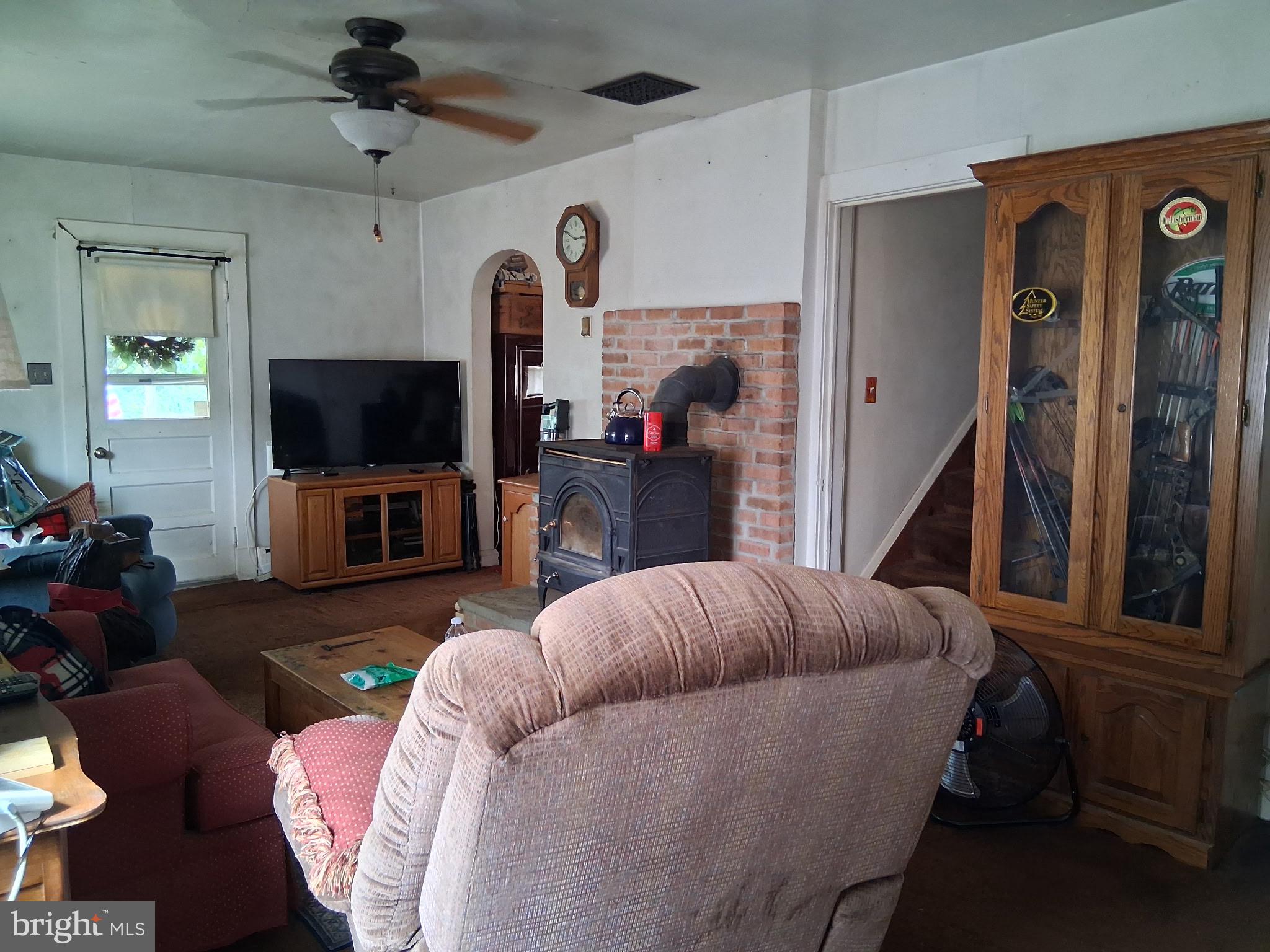 14021 Triadelphia Road Glenelg, MD 21737 - Photo 4 of 12 a living room with furniture and a flat screen tv