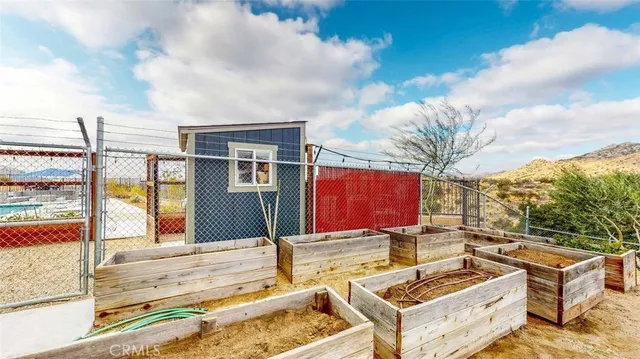 a view of backyard with swimming pool and furniture