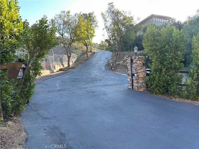 a view of a street with trees on both side of the road
