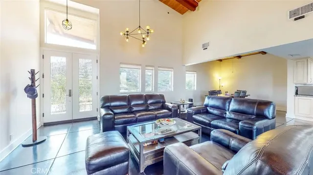 a living room with furniture a flat screen tv and a window
