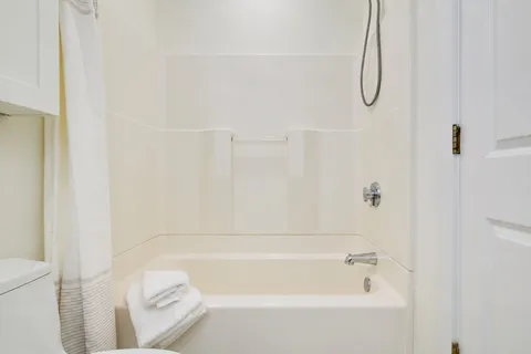a bathroom with a bath tub with a shower