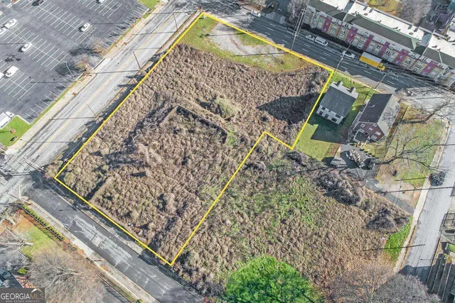 an aerial view of a residential houses with outdoor space