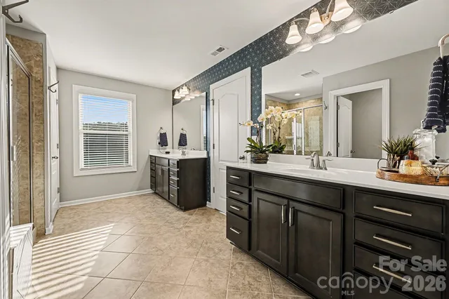 a spacious bathroom with a sink double vanity and a mirror