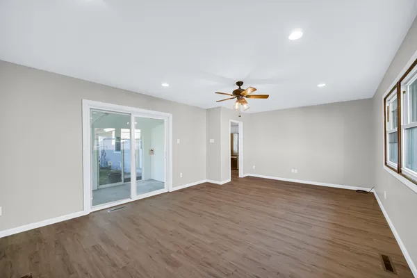 wooden floor in an empty room with a window