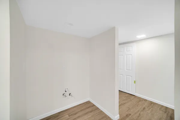 a view of room with wooden floor