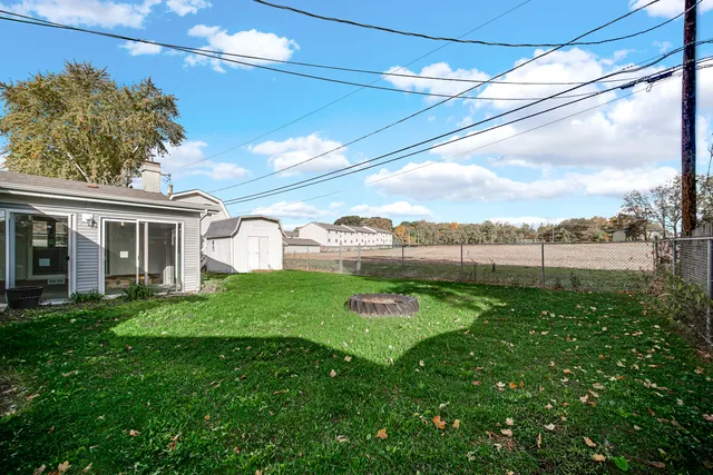 a view of a house with a backyard and a patio