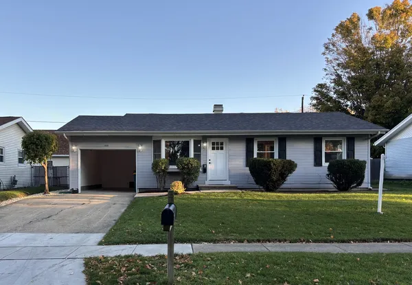 a front view of house with yard and green space