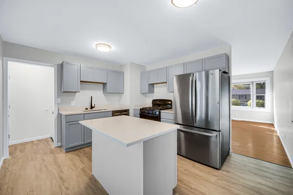 a kitchen with wooden cabinets and stainless steel appliances