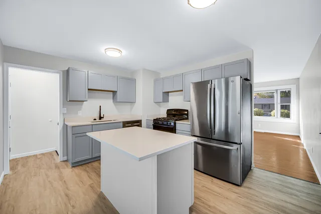 a kitchen with wooden cabinets and stainless steel appliances
