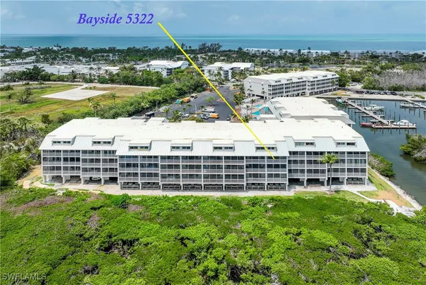 a view of a large building with a yard and lake view