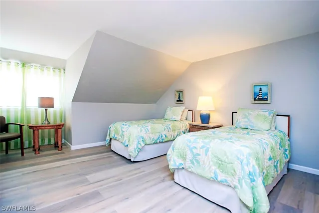 a bedroom with two beds and a table