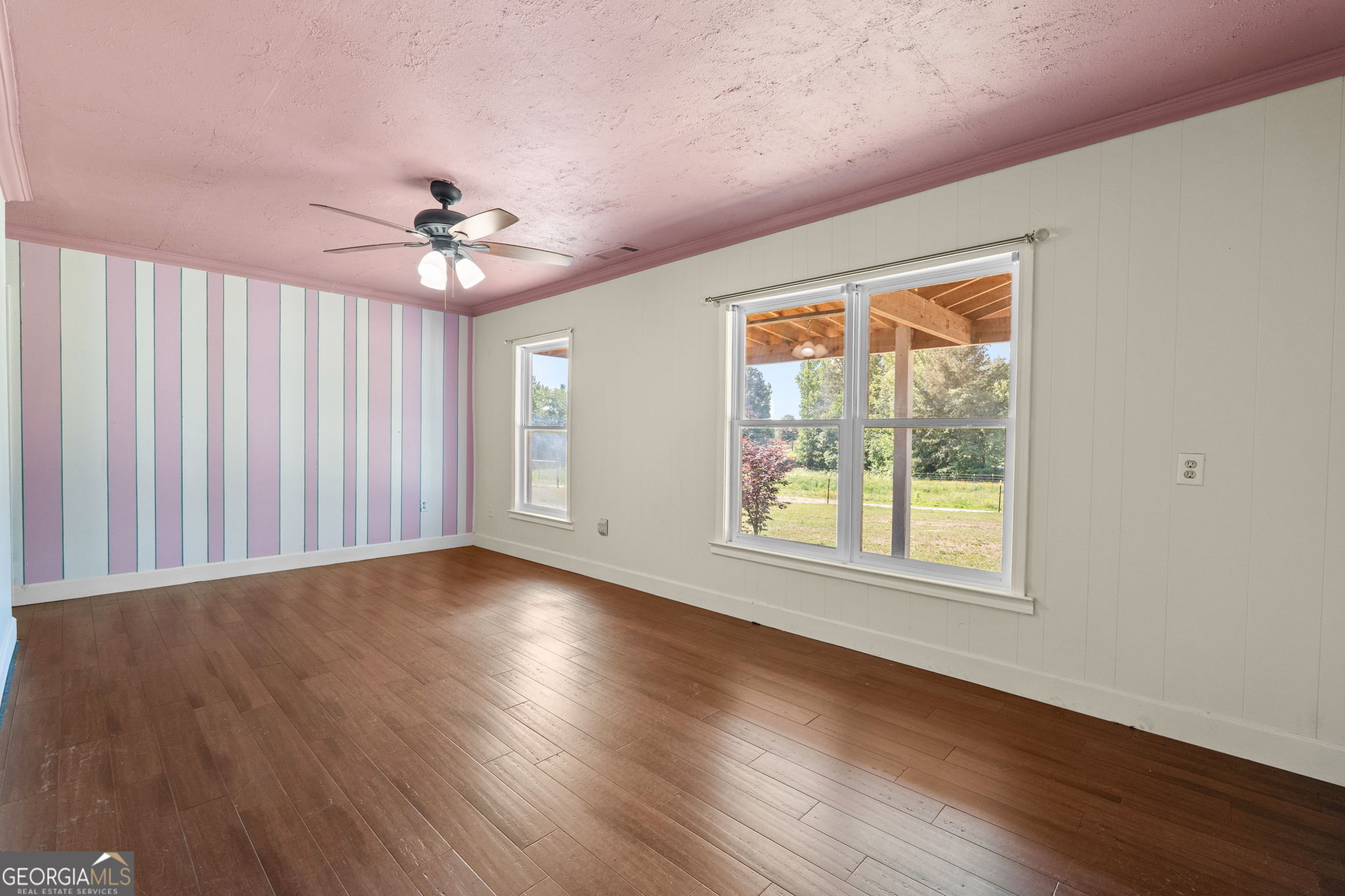 49 Frost Road Bowdon, GA 30108 - Photo 27 of 60 an empty room with wooden floor and windows