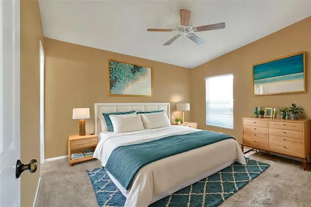 an aerial view of residential houses with outdoor space and trees