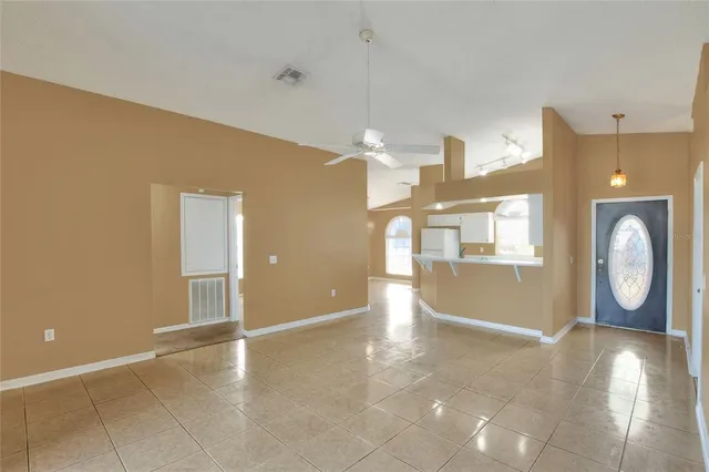 a view of a kitchen with kitchen island a window a sink and a dining table