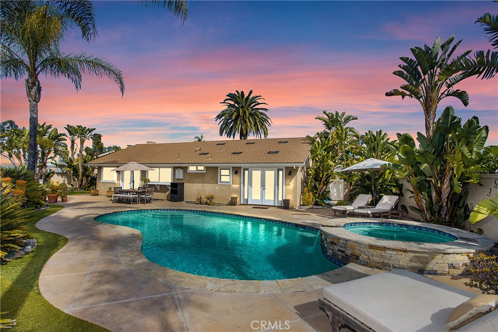a view of a house with swimming pool and sitting area