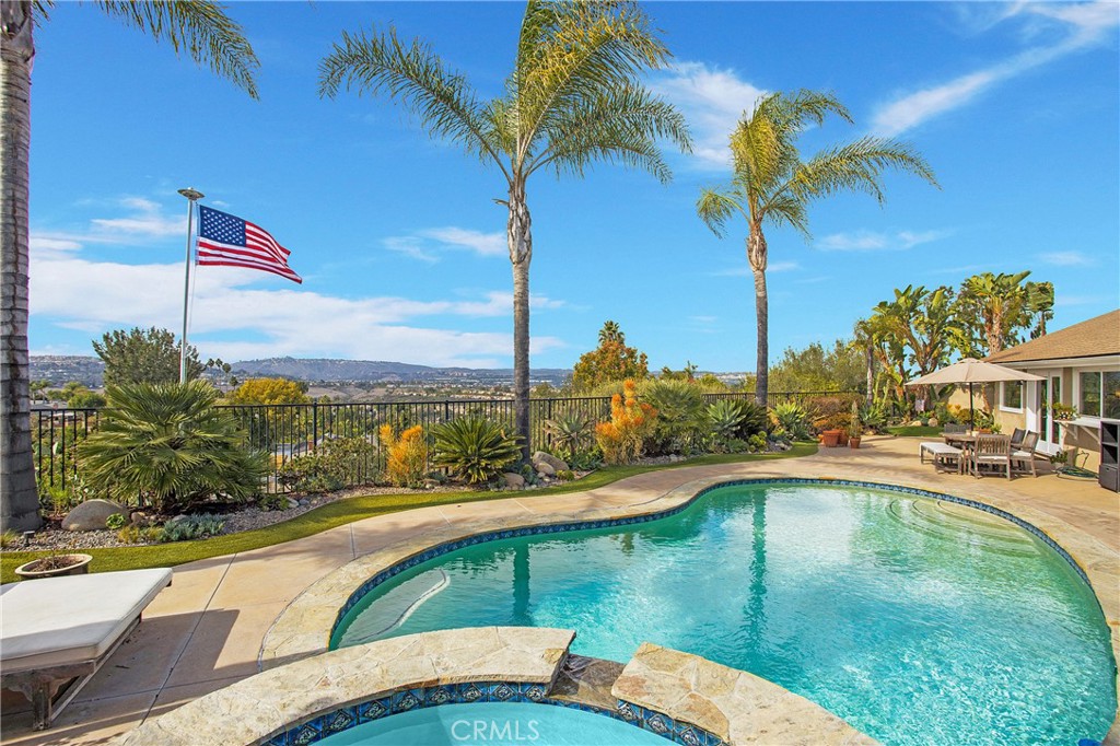 25222 Del Rio Laguna Niguel, CA 92677 - Photo 27 of 37 a view of a swimming pool with a table and chairs