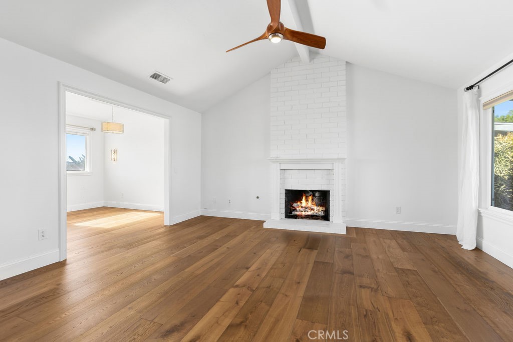 25222 Del Rio Laguna Niguel, CA 92677 - Photo 6 of 37 a view of an empty room with wooden floor fireplace and a window