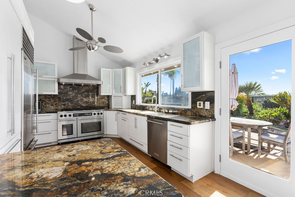 25222 Del Rio Laguna Niguel, CA 92677 - Photo 10 of 37 a kitchen with granite countertop white cabinets and white appliances