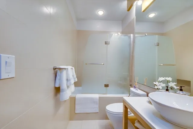 a bathroom with a sink toilet and shower