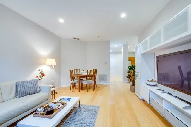a living room with furniture and wooden floor