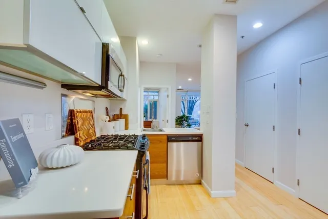 a kitchen with stainless steel appliances granite countertop a sink and a stove